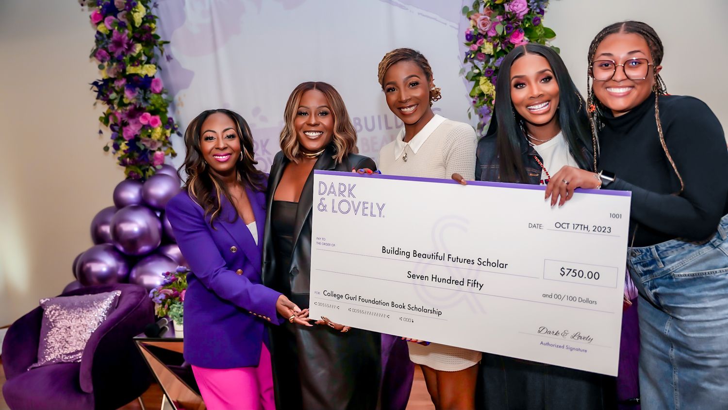 Jessica with Dark and Lovely presenting a College Gurl Foundation book scholarship